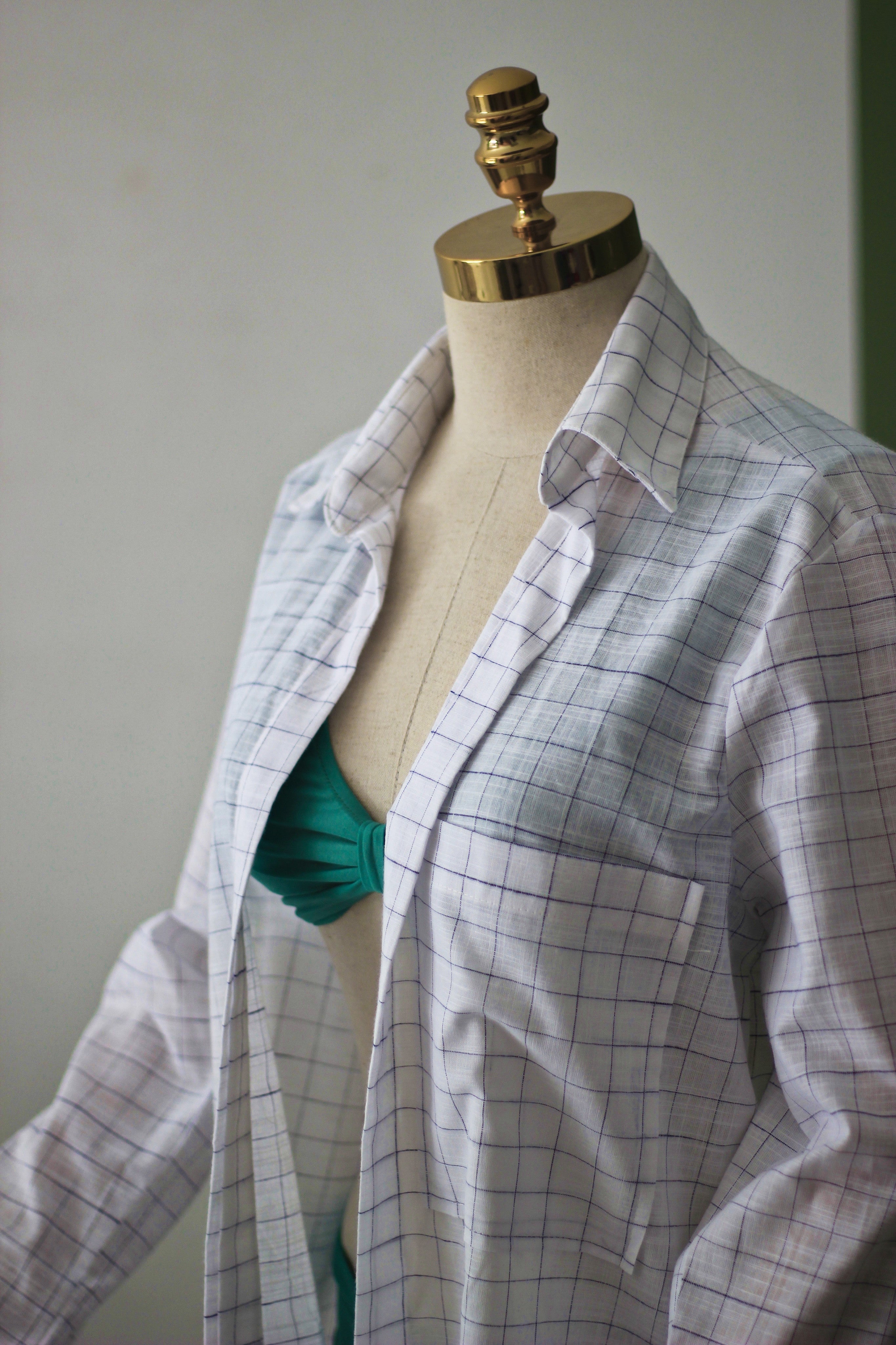Plaid shirt on a mannequin against a plain background