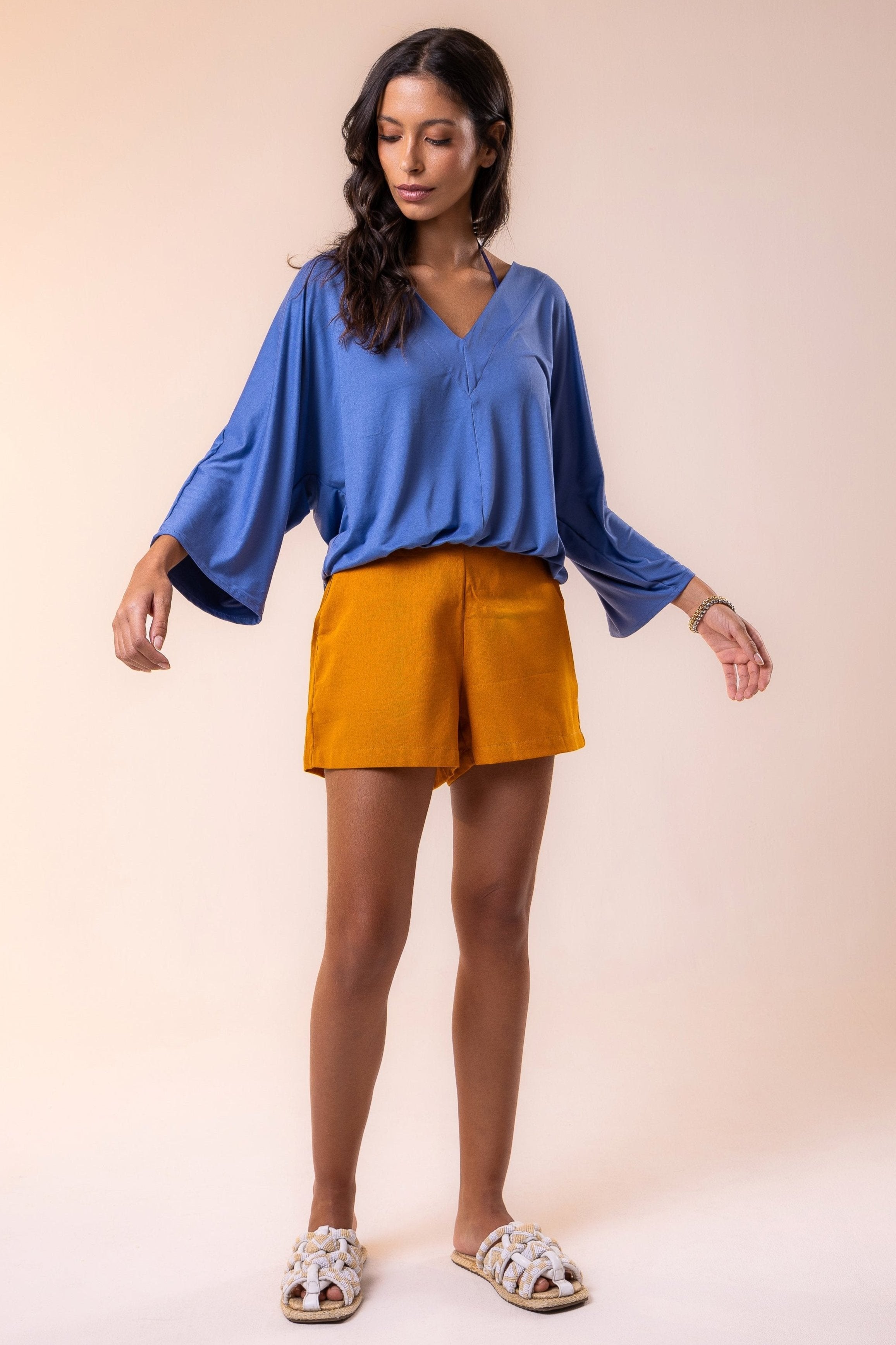 Tailored high-rise resort shorts in rich ochre linem — a timeless piece with a minimalist silhouette and refined finish, perfect for warm-weather styling.